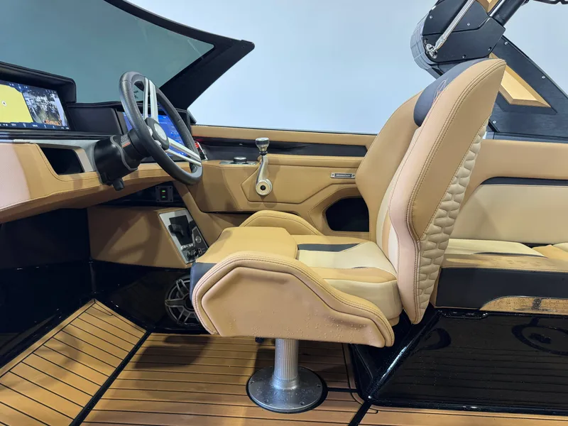 Slide: The Image of The image shows the interior of a 2025 MasterCraft X24 with a beige leather seat and modern dashboard. - 25