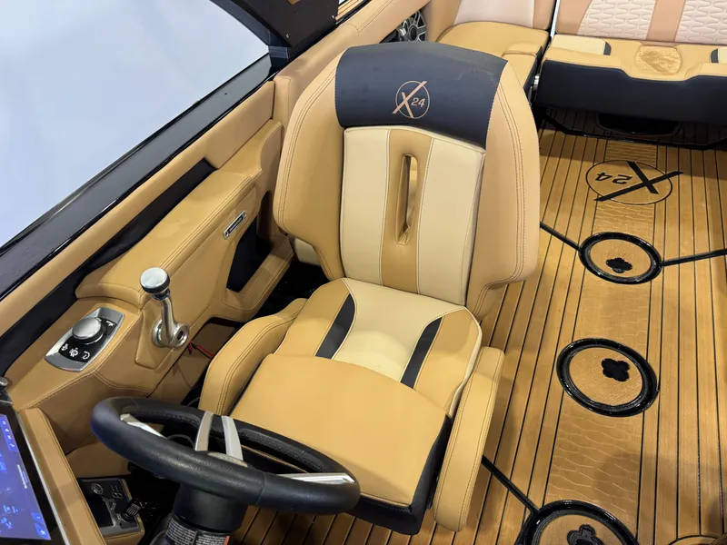 Slide: The Image of The image shows the interior of a 2025 MasterCraft X24 with luxurious seating and wood flooring. - 23