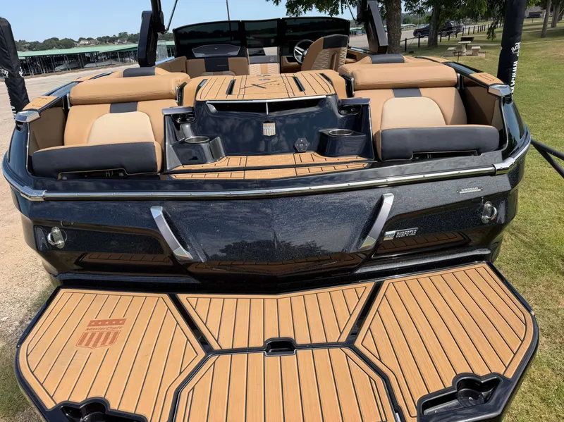 Slide: The Image of The image shows the rear of a 2025 MasterCraft X24 with sleek seating and teak-style decking. - 3