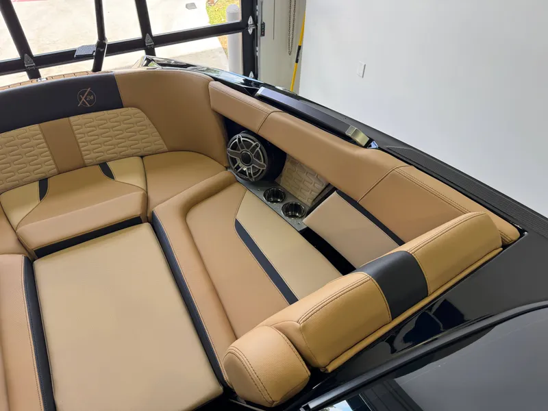 Slide: The Image of Interior of a 2025 MasterCraft X24 with beige upholstery and speakers. - 20