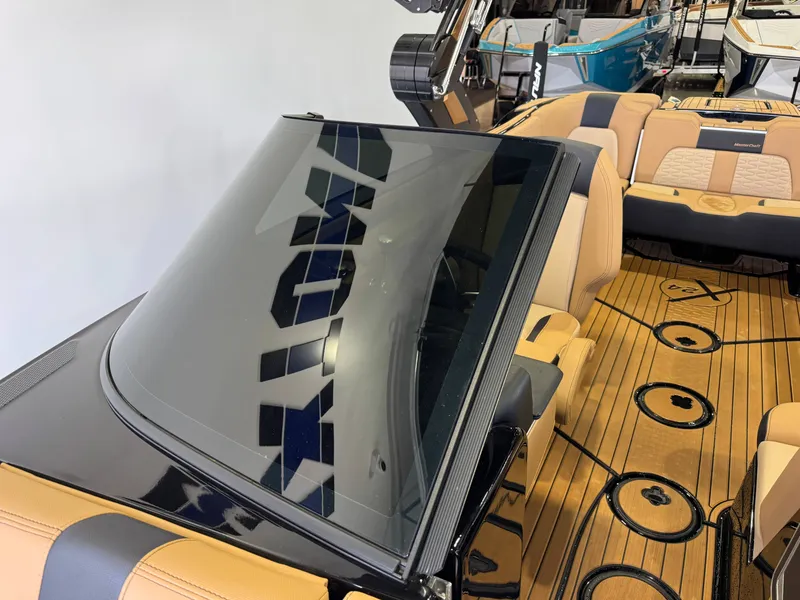 Slide: The Image of The image shows the interior of a 2025 MasterCraft X24 boat with sleek seating and wood flooring. - 22