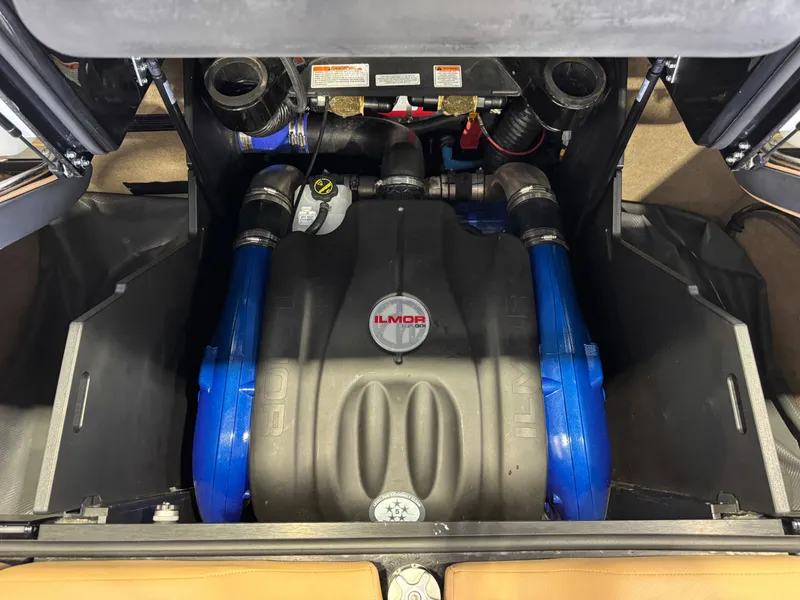 Slide: The Image of The engine compartment of a 2025 MasterCraft X24 features a powerful Ilmor engine with blue components. - 29