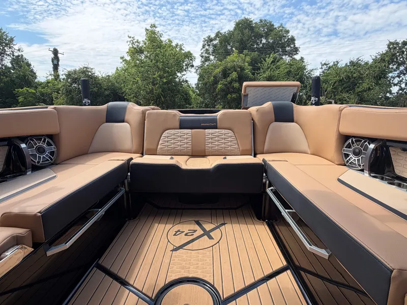 Slide: The Image of The image shows the luxurious interior of a 2025 MasterCraft X24 boat with beige upholstery. - 8