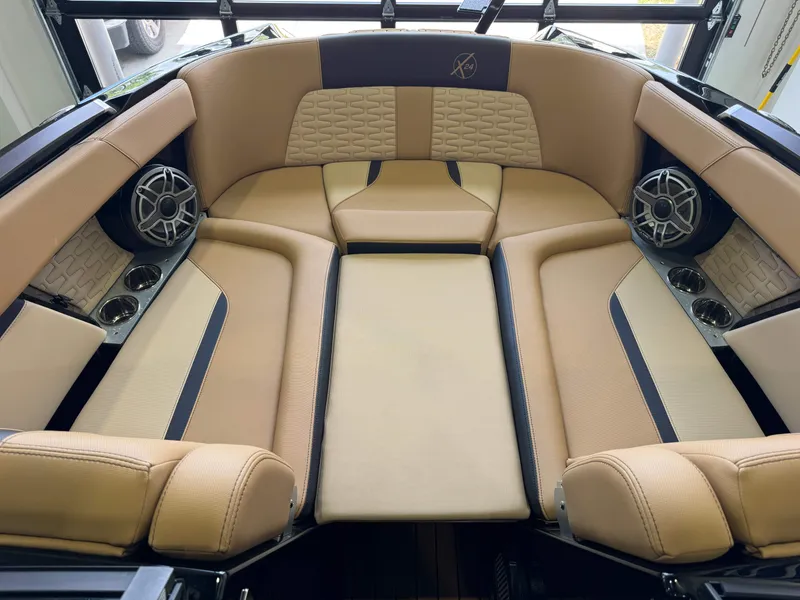 Slide: The Image of The image shows the interior of a 2025 MasterCraft X24 with beige upholstery and speakers. - 19