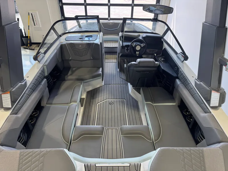 Slide: The Image of The image shows the interior of a 2022 Nautique Super Air Nautique G21 with gray upholstery and modern design. - 13
