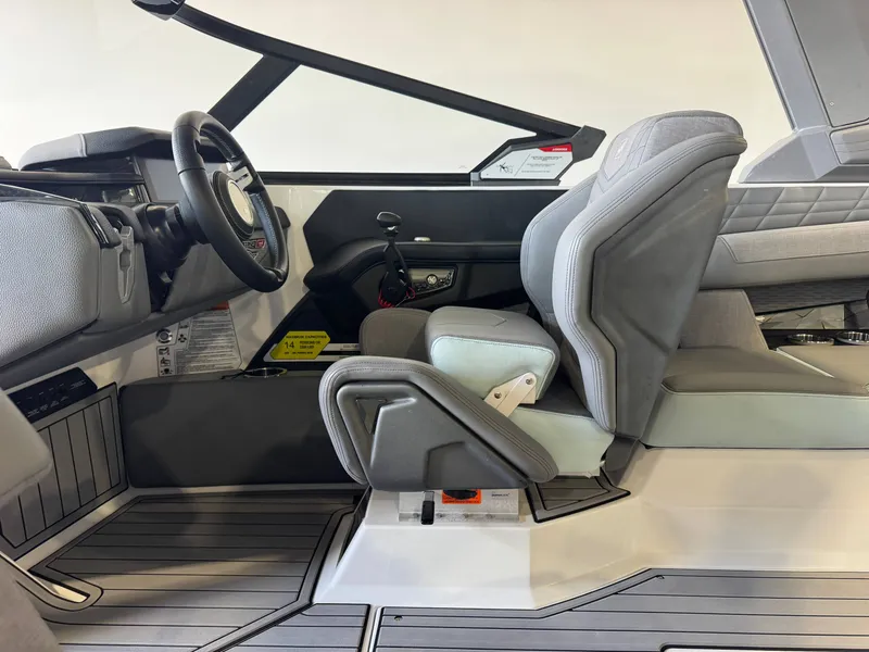 Slide: The Image of The image shows the cockpit of a 2022 Nautique Super Air Nautique G21 with gray seats and modern design. - 23