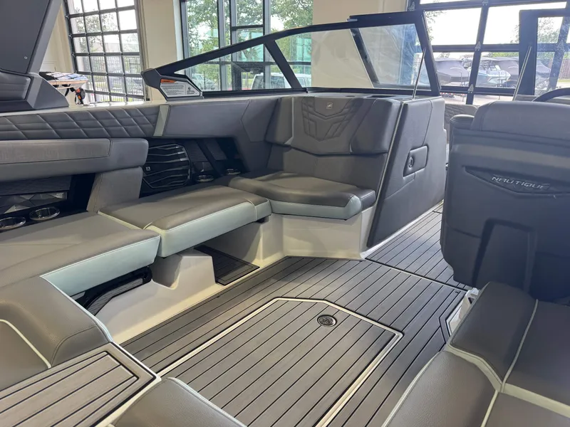 Slide: The Image of The image shows the interior of a 2022 Nautique Super Air Nautique G21 with gray upholstery and modern details. - 14