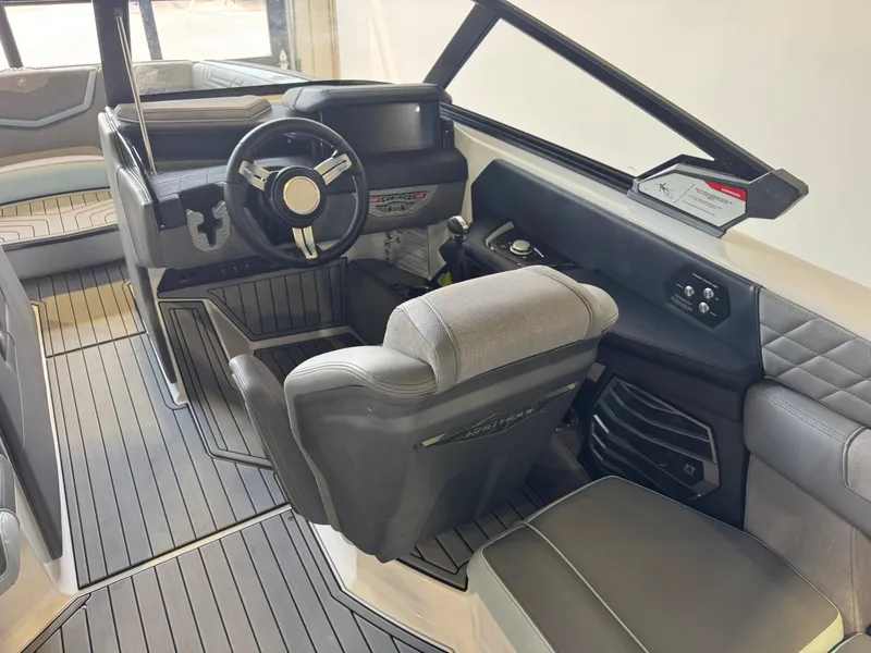 Slide: The Image of The image shows the cockpit of a 2022 Nautique Super Air Nautique G21 with modern seating and controls. - 24