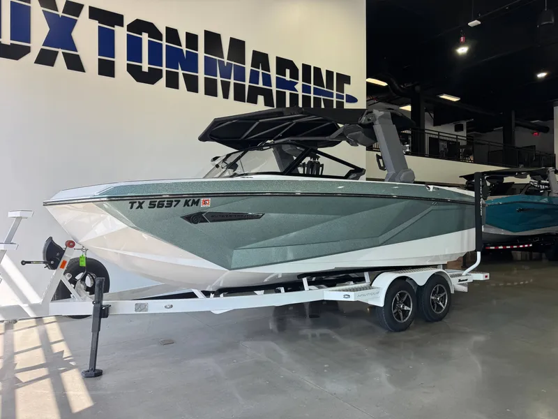 Slide: The Image of A 2022 Super Air Nautique G21 boat on a trailer in a showroom. - 3
