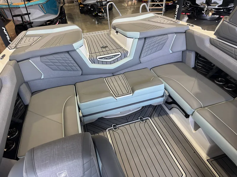 Slide: The Image of The image shows the interior of a 2022 Nautique Super Air Nautique G21 with gray upholstery and modern details. - 16
