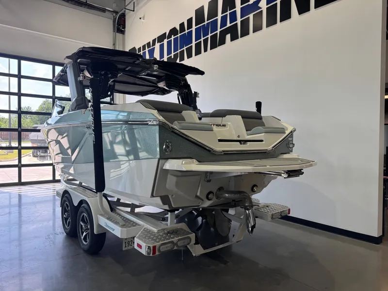 Slide: The Image of A 2022 Nautique Super Air Nautique G21 on a trailer inside a showroom. - 5