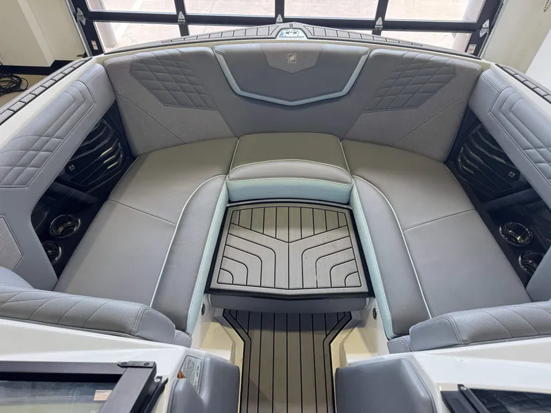 Slide: The Image of The image shows the bow area of a 2022 Nautique Super Air Nautique G21 with gray upholstery and sleek details. - 17
