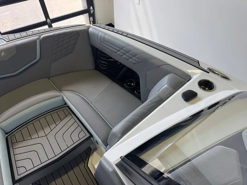 Slide: The Image of The image shows the interior of a 2022 Nautique Super Air Nautique G21 with gray upholstery. - 18