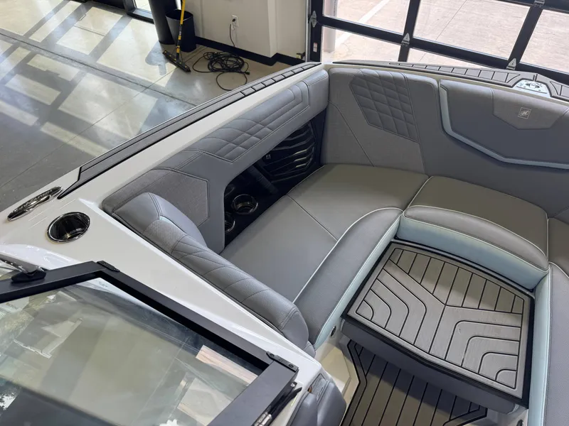 Slide: The Image of The image shows the interior of a 2022 Nautique Super Air Nautique G21 with gray upholstery and modern details. - 19