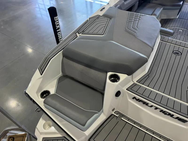 Slide: The Image of The image shows the stern of a 2022 Nautique Super Air Nautique G21 with gray upholstery. - 12
