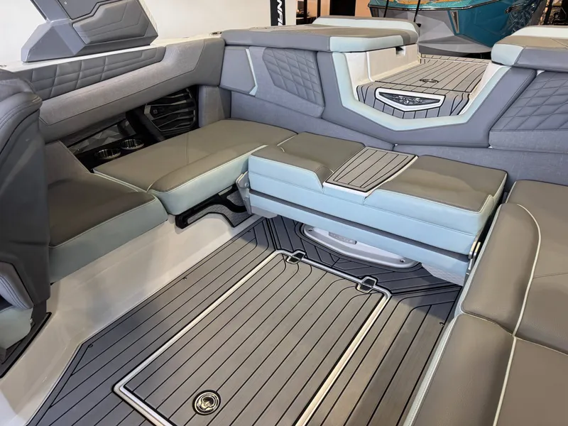 Slide: The Image of Interior of a 2022 Nautique Super Air Nautique G21 with gray and blue upholstery. - 15