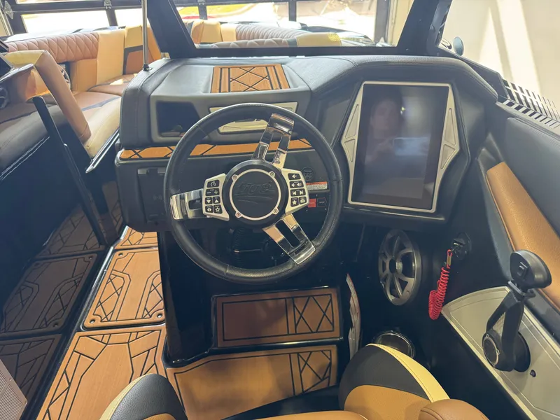 Slide: The Image of The image shows the cockpit of a 2021 Tigé 25ZX with a modern steering wheel and large display. - 24