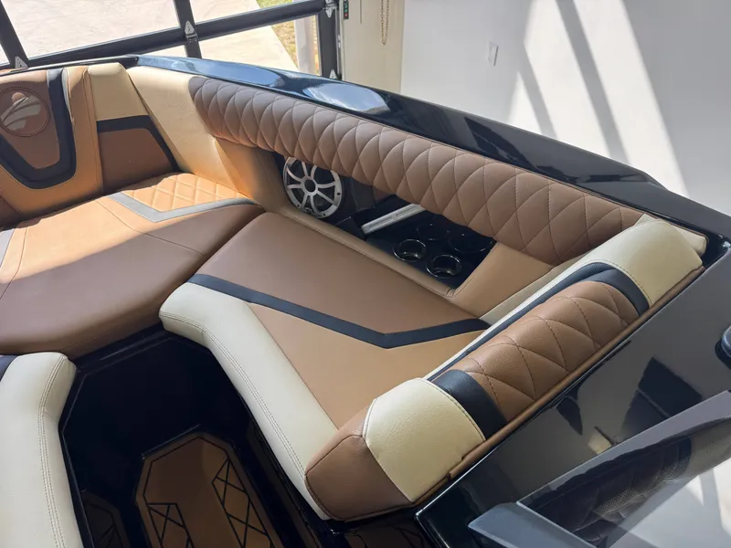 Slide: The Image of The image shows the interior of a 2021 Tigé 25ZX with luxurious, upholstered seating. - 17