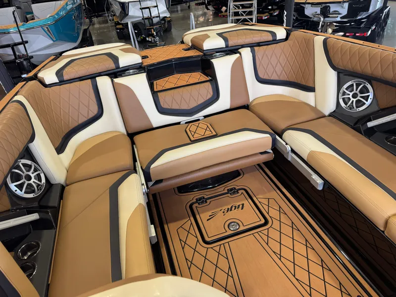 Slide: The Image of Interior of a 2021 Tigé 25ZX with luxurious brown and cream upholstery and speakers. - 15