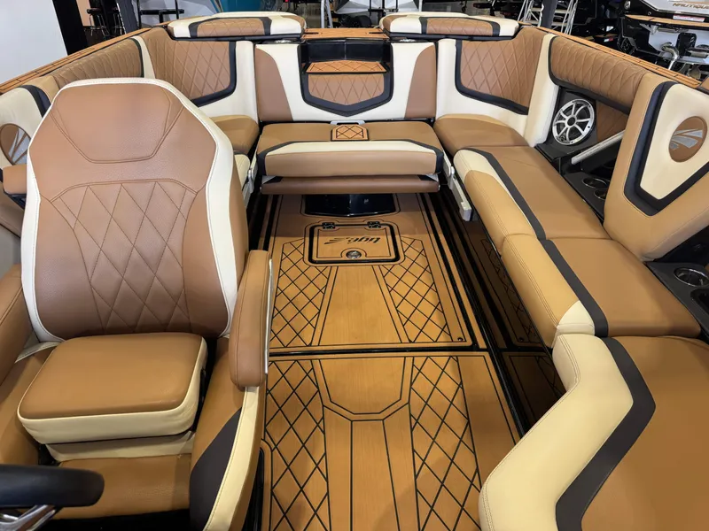 Slide: The Image of The image shows the luxurious interior of a 2021 Tigé 25ZX boat with elegant brown leather seating. - 21