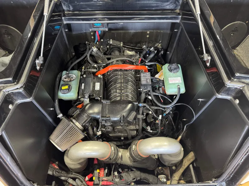 Slide: The Image of The engine compartment of a 2021 Tigé 25ZX shows a powerful engine with various components. - 26
