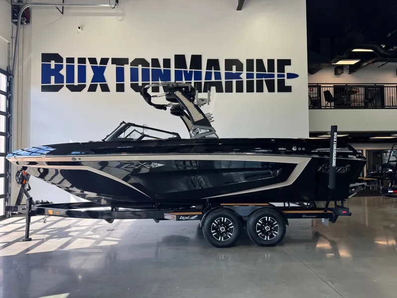 Slide: The Image of A black 2021 Tigé 25ZX boat on a trailer in a showroom. - 4