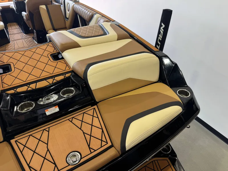 Slide: The Image of The image shows the luxurious interior of a 2021 Tigé 25ZX with elegant seating and cup holders. - 10
