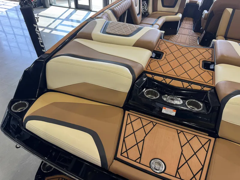 Slide: The Image of The image shows the luxurious interior of a 2021 Tigé 25ZX boat with elegant seating and wood accents. - 11