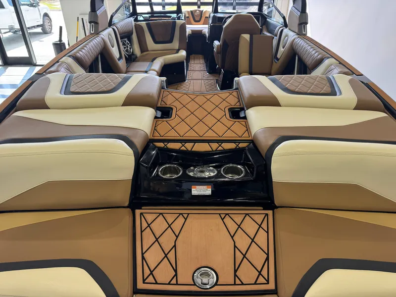 Slide: The Image of Interior of a 2021 Tigé 25ZX with luxurious brown and cream upholstered seating. - 9