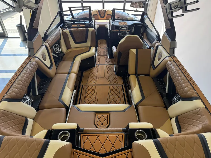 Slide: The Image of Interior of a 2021 Tigé 25ZX with luxurious brown upholstery and modern details. - 12