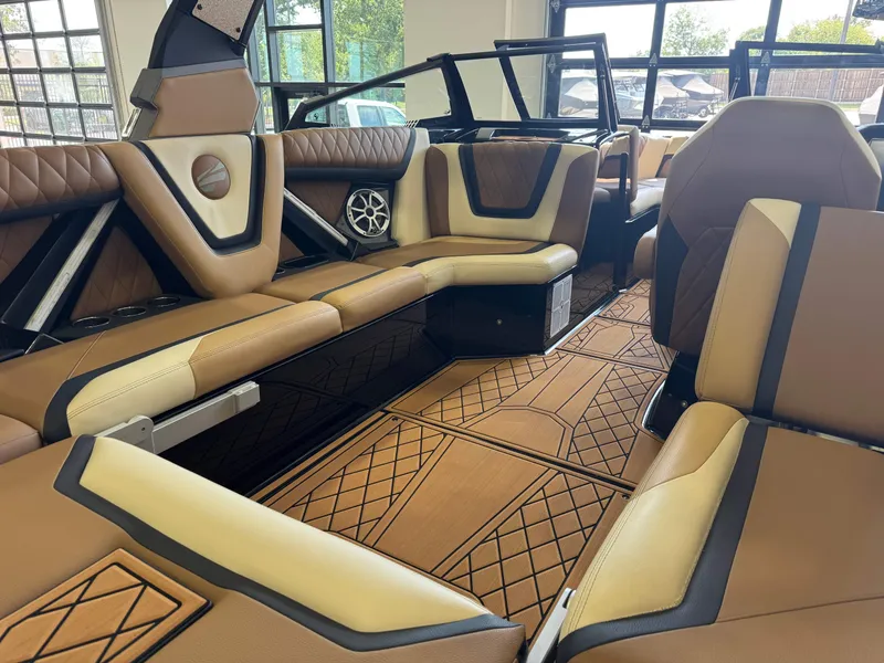 Slide: The Image of The image shows the luxurious interior of a 2021 Tigé 25ZX boat with elegant brown seating. - 13