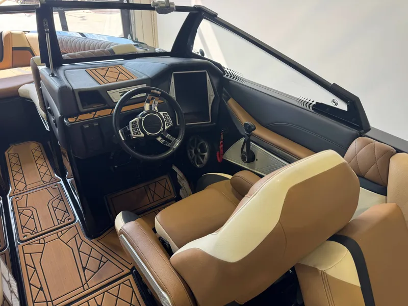 Slide: The Image of The image shows the cockpit of a 2021 Tigé 25ZX boat with modern controls and luxurious seating. - 23