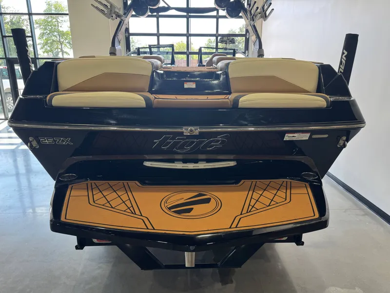Slide: The Image of The image shows the rear of a 2021 Tigé 25ZX boat with stylish design and upholstery. - 8