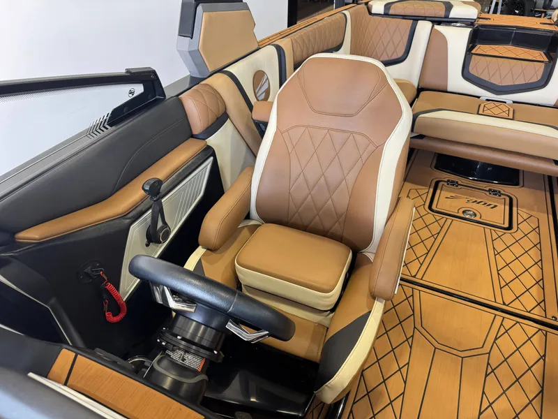 Slide: The Image of The image shows the interior of a 2021 Tigé 25ZX with elegant brown and cream upholstery. - 20