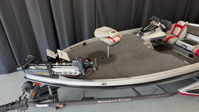 Slide: The Image of A 2015 Ranger Tugs Z520C boat with gray carpeting and red accents, on a trailer. - 4