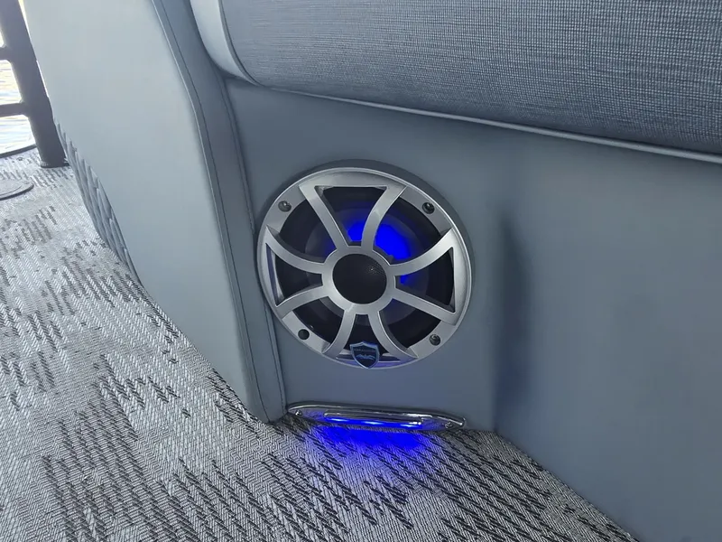 Slide: The Image of A speaker with blue lighting is integrated into the gray upholstery of a boat. - 18