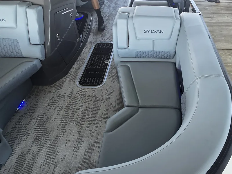 Slide: The Image of The image shows the interior of a 2027 Sylvan G-3 SLZ boat with gray upholstery. - 34