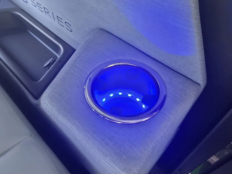 Slide: The Image of A lit cup holder in a modern boat, surrounded by gray upholstery. - 20