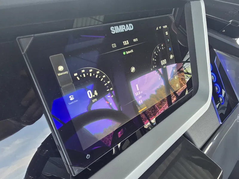 Slide: The Image of The image shows a modern boat dashboard with a Simrad display showing navigation data. - 25