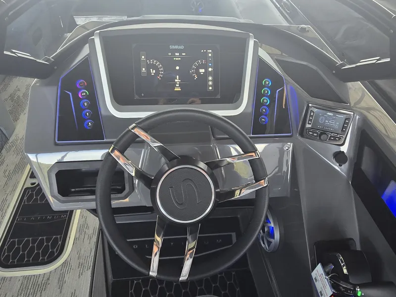 Slide: The Image of The image shows the modern helm of a 2027 Sylvan G-3 SLZ boat with a digital display and sleek controls. - 24