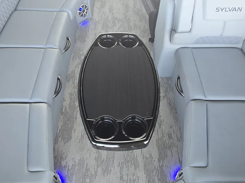 Slide: The Image of The image shows the interior of a 2027 Sylvan G-3 SLZ with gray seating and a table. - 16