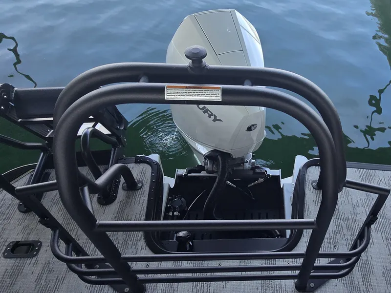 Slide: The Image of A Sylvan G-3 SLZ boat with an outboard motor on calm water. - 7