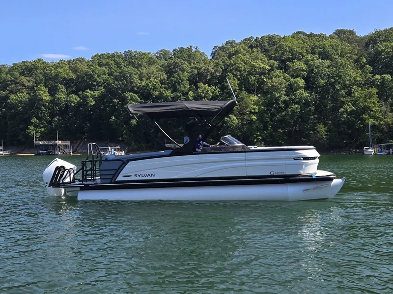 Slide: The Image of A modern pontoon boat by Sylvan, model G-3 SLZ, year 2027, on a calm lake. - 4