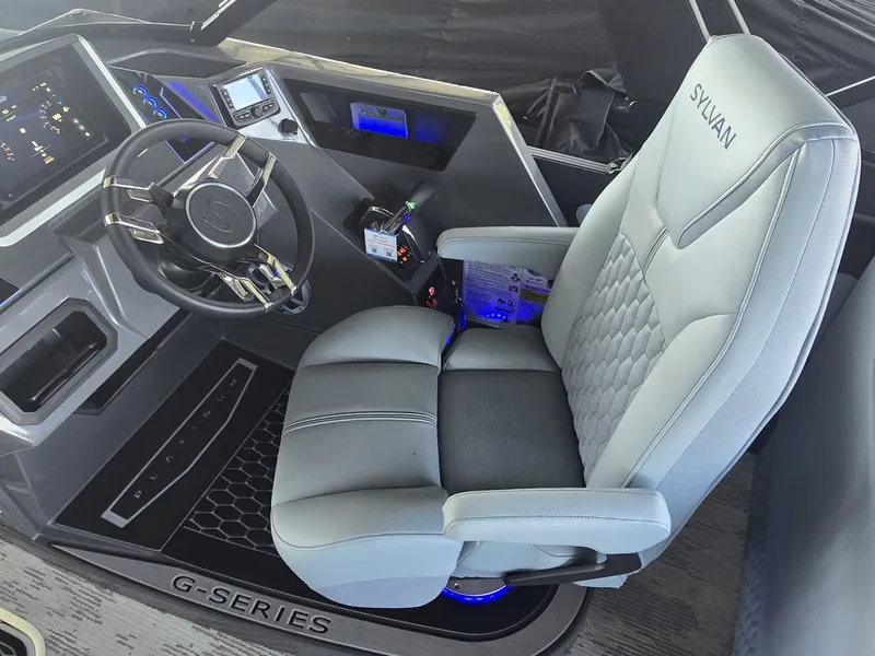 Slide: The Image of The image shows the helm of a 2027 Sylvan G-3 SLZ with a luxurious captain's chair. - 23