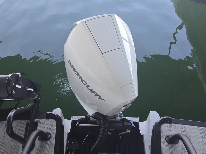 Slide: The Image of A Mercury outboard motor is mounted on the stern of a boat floating on calm water. - 6
