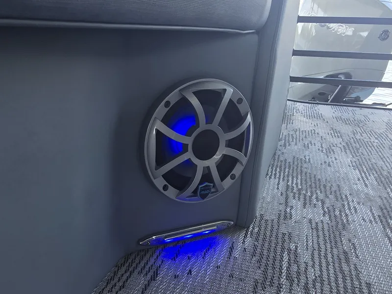 Slide: The Image of A speaker with blue lighting is integrated into the gray interior paneling of a boat. - 19