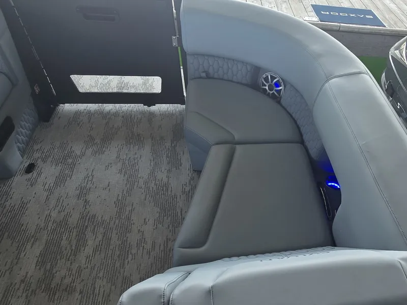 Slide: The Image of The image shows a luxurious gray seating area in a modern boat, featuring blue speakers. - 30