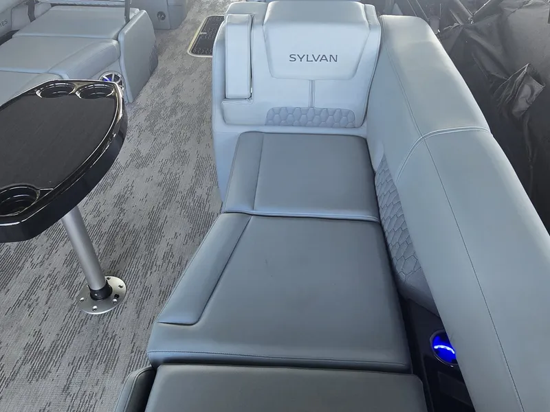 Slide: The Image of The image shows a luxurious gray boat seat with a small table beside it. - 17