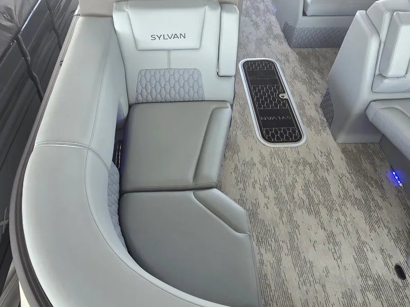 Slide: The Image of The image shows a luxurious, upholstered seating area in a modern boat with gray carpeting. - 33