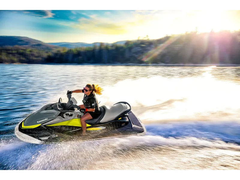 Slide: The Image of A person rides a Kawasaki Jet Ski® ST® 160X on a lake at sunset. - 16